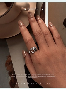 Detail view of retro S925 silver scorpion open ring with a black pear-shaped gemstone