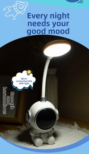 Detailed view of astronaut LED desk lamp with adjustable neck and warm white light glow