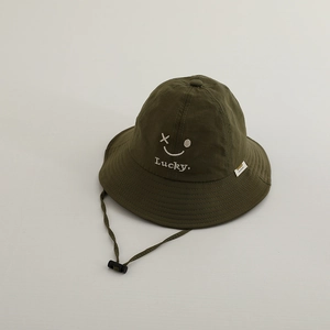 Detail of embroidered smiling face and Lucky text on olive green quick-dry sun hat