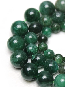 Detailed close-up of green mica round beads showing natural texture and smooth polished finish