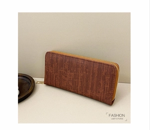 Detail of vintage brown textured leather long wallet with golden zipper closure