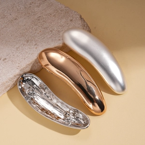 Minimalist geometric water drop brooches in polished gold and matte silver finishes