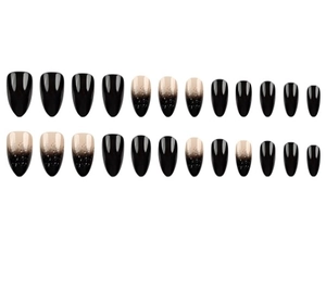 Detail of almond-shaped black gradient press-on nails with glitter finish on white background