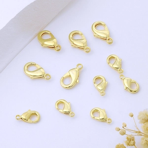 Flat lay of ten polished 18K gold-plated lobster clasps for DIY jewelry making