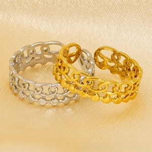 Detail of gold and silver cutout chain rings with vintage dot texture and open bands