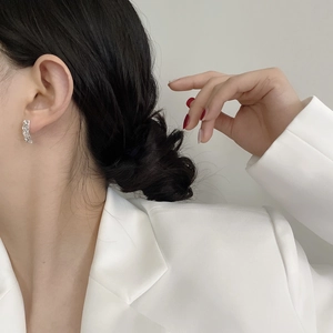 Close-up of minimalist S925 sterling silver hammered texture earrings worn by a model