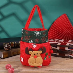 Detailed view of plush reindeer Christmas gift bag with festive embroidery and red fabric