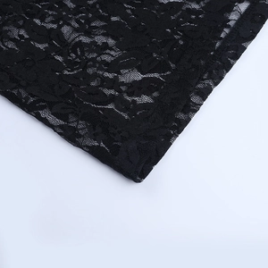 Close-up of black floral lace fabric showing delicate hollow embroidery and textures