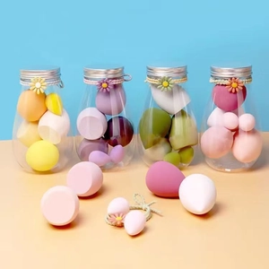 Colorful makeup sponge set with teardrop shapes in elegant glass jars with daisy accents