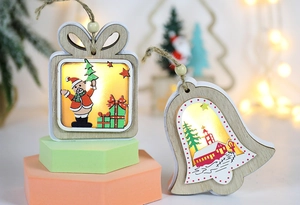 Close-up of glowing wooden Christmas ornaments with warm LED lights and bell details