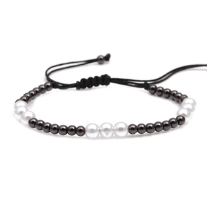 Braided bracelet with white pearls and dark grey metal beads on adjustable black cord