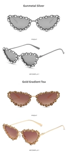 Close-up of cat-eye rhinestone sunglasses with gunmetal and gold metallic frames