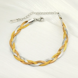 Close-up of two-tone braided stainless steel bracelet with lobster clasp and extender