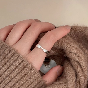 Close-up of minimalist 925 sterling silver twisted mobius ring on a hand