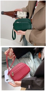 Close-up of mini PU leather coin purses in green and red with elegant litchi texture