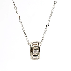 Macro detail of silver stainless steel pendant with rectangle-cut crystal stones