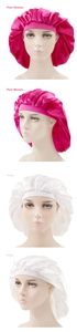 Detail view of large satin sleep bonnets in plum blossom and white with elastic wide bands