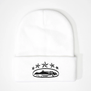Close-up of white knitted beanie with five black embroidered stars and mountain landscape