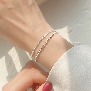 Double-layer silver beaded chain bracelet for women on wrist with natural light