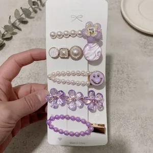 Detailed set of 5 purple alloy hair clips with pearls and crystals on display card