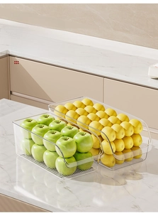 Macro view of transparent food grade PET storage bins holding fresh apples and lemons