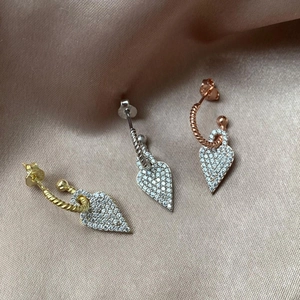 Detailed view of heart drop earrings in gold, silver and rose gold with pavé cubic zirconia