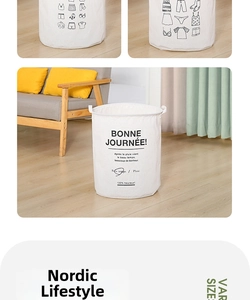Detail of a large white canvas laundry basket with handles and Nordic style print