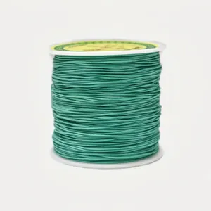 Macro detail of 0.8mm emerald green jade thread spool for manual jewelry braiding