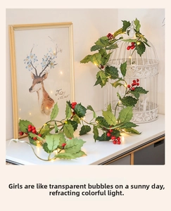 Close-up of warm LED lights with holly leaves and red berries for Christmas decor