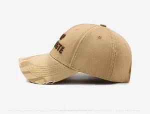 Close-up of distressed khaki baseball cap with 3D embroidery and vintage ripped details