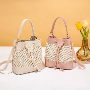 Chic woven bucket bag in cream and dusty pink with leather stitching for summer style