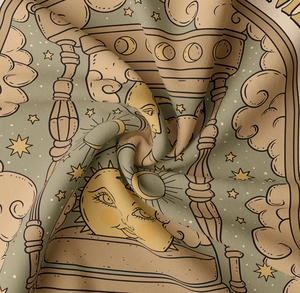 Close-up of tapestry fabric showing tarot sun and moon design with fine textile texture