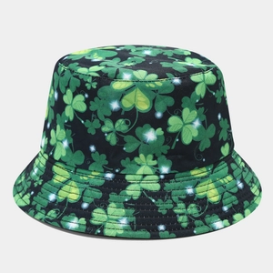 Close-up of green shamrock clover print on high-quality black fabric of bucket hat