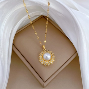 Elegant gold titanium necklace with bird nest pearl pendant and crystals on silk