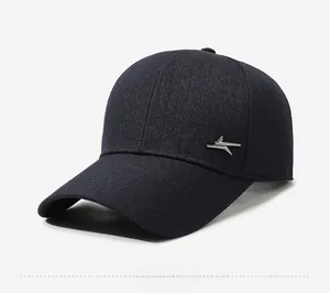 Detailed side view of textured baseball cap fabric with a silver geometric logo embellishment