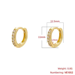 Detailed view of gold huggie earrings with single row zircon inlay and 12.5mm dimensions