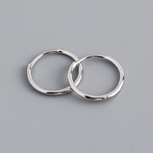 Macro shot of polished S925 sterling silver hoop earrings with a mirror finish