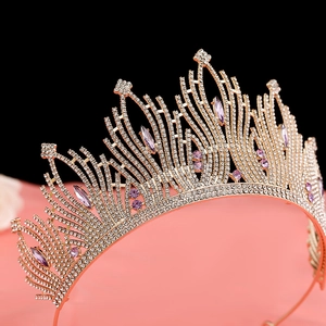 Detail of baroque crown with purple marquise gems and white rhinestones on gold base