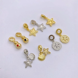 Detailed view of starfish and shell charms with gold and silver plating for DIY jewelry