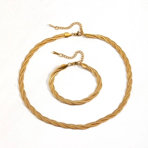 Golden titanium steel jewelry set featuring a braided necklace and bracelet with lobster clasp