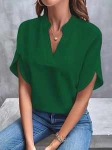 Detail of dark green V-neck blouse featuring elegant ruffle sleeves and chiffon texture