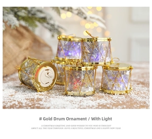Close-up of golden Christmas drum ornaments with LED lights and snowflake patterns