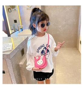 Pink rabbit-shaped crossbody bag for girls with cute ears and bow detail on model