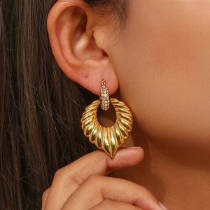 18K gold plated leaf hoop earrings with shimmering crystals shown on model