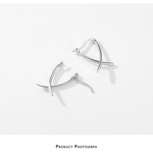 Detailed macro view showing the S925 sterling silver hallmark on geometric curve earrings