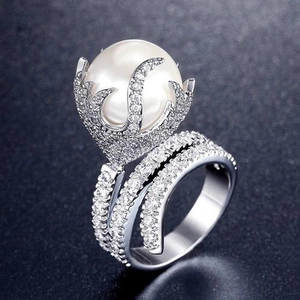 Elegant silver ring with a large white pearl and triple cross band set with zircons