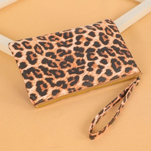 Detail shot of leopard print clutch wallet with golden zipper and wristlet strap