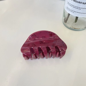 Y2K style dark magenta marble hair claw clip with floral daisy accents on white surface