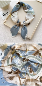 Detailed view of luxury printed silk scarf with nautical motifs and smooth texture