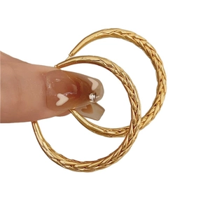 Golden retro twisted metal hoop earrings with elegant woven texture for daily wear
